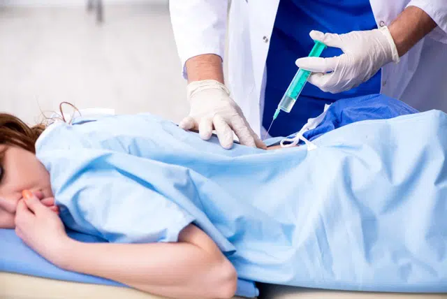 Female patient getting a stem cell therapy in the clinic