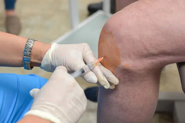Doctor Injects Connective tissue matrix into Patientâ€™s Damaged Knee