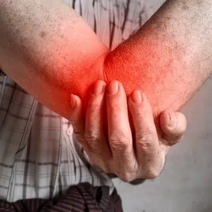 A man suffering from severe elbow pain