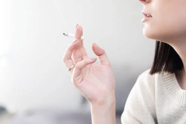 Young woman smoking a cigarette.