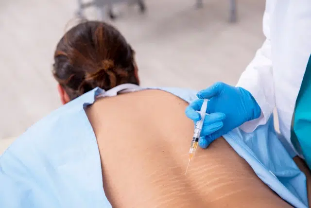 Doctor giving a patient regenerative medicine treatment.